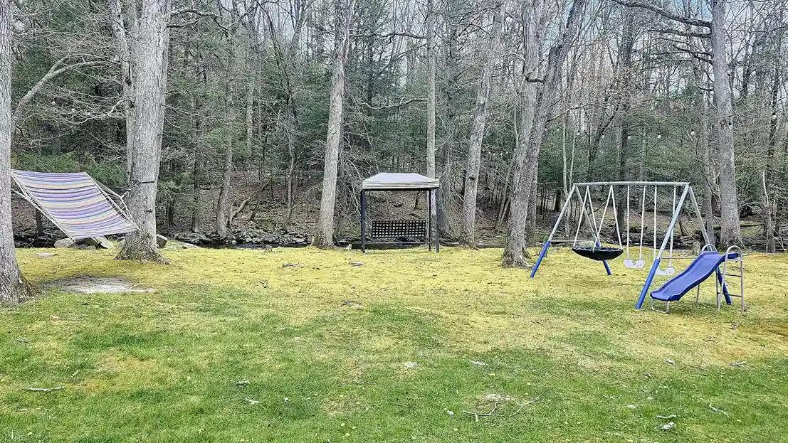 Waterfront yard with playset, & firepit